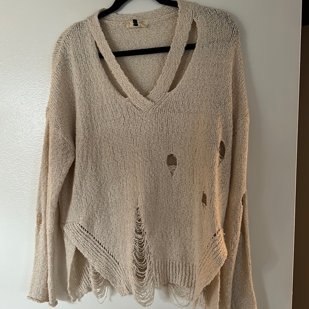 Distressed white sweater